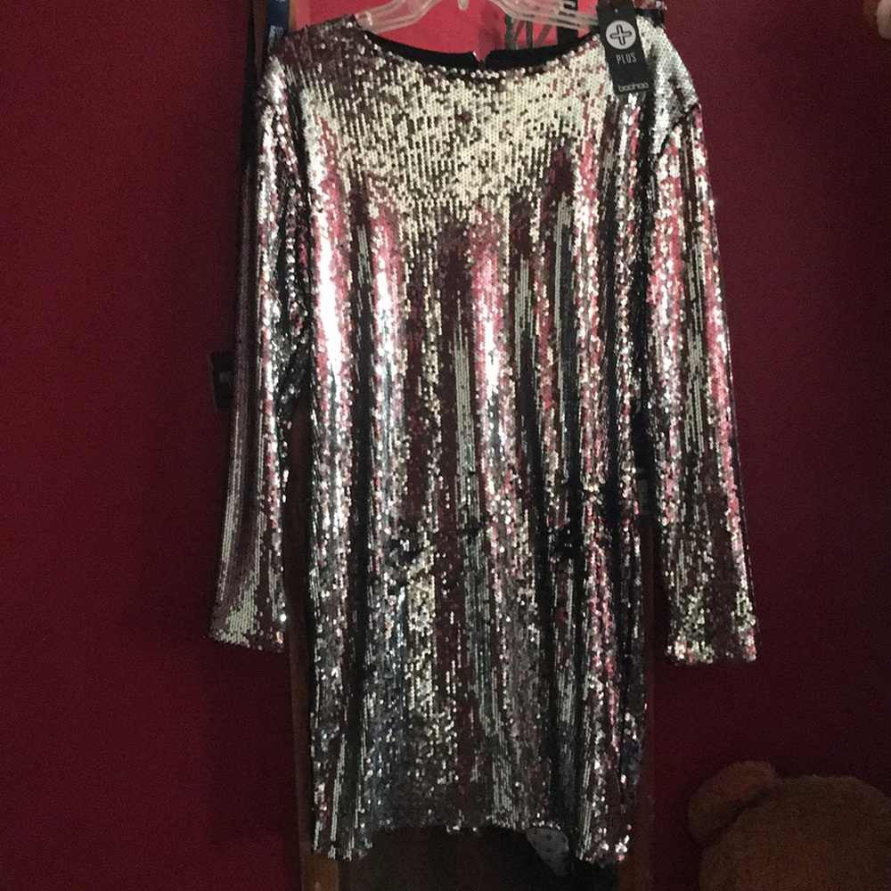 A silver sequin long sleeve dress